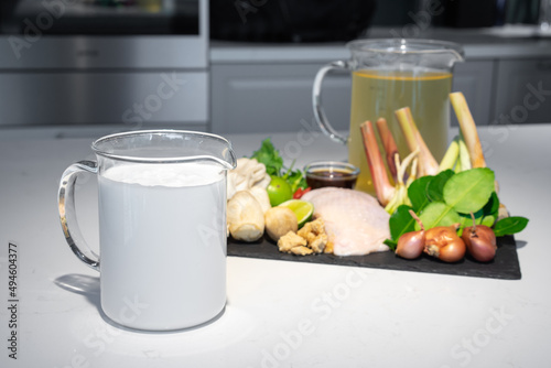Focus on coconut cream milk, one of ingredients set for Thai food, Coconut milk with chicken soup menu. The ingredients are chicken vegetable and many types of herbs together combine as a great dish.