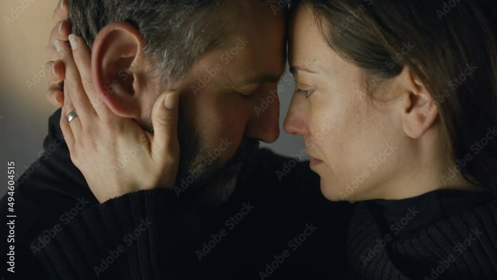 Close-up of woman crying when hugging her husband.
