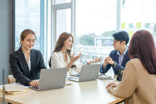 Entrepreneurs and business people conference in modern meeting room, happy multiracial coworkers have fun cooperating working together at office meeting, asian teamwork concept