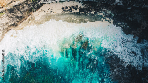 Aerial view to ocean waves. Blue water background