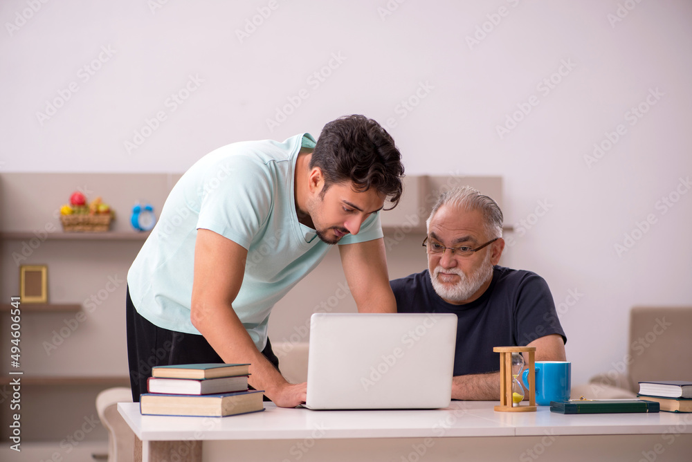 Grandfather and grandson at home with computer Grandfather and grandson at home with computer