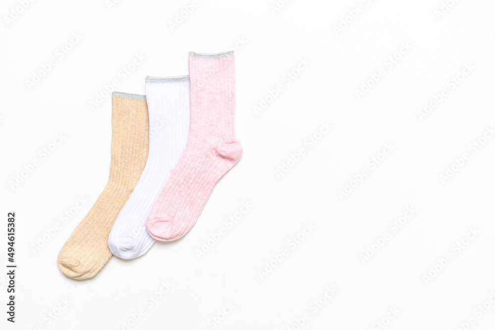 Various modern trendy women's cotton socks set on white background. Fashionable socks store. Socks shopping, sale, merchandise, advertisement concept. Flat lay, top view, copy space Various modern trendy women's cotton socks set on white background. Fashionable socks store. Socks shopping, sale, merchandise, advertisement concept. Flat lay, top view, copy space