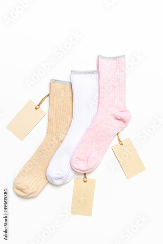Various modern trendy women's cotton socks set with price tags on white background. Fashionable socks store. Socks shopping, sale, merchandise, advertisement concept. Flat lay, top view
