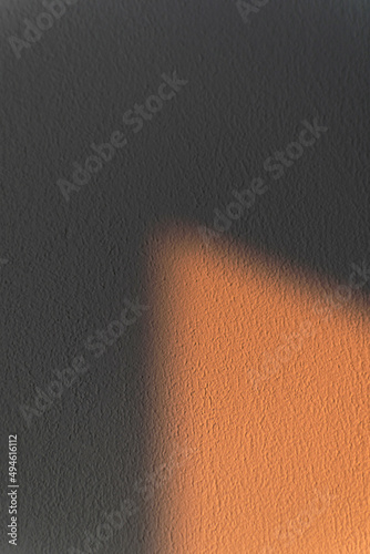 Textured wall with shadow and spot of light. Abstract background.