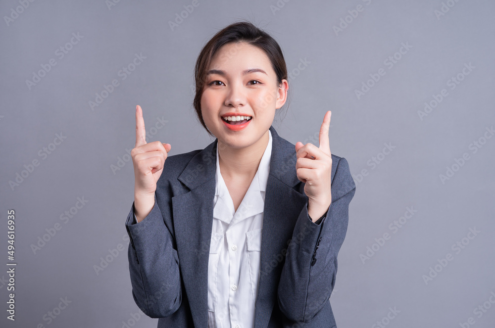 Portrait of a beautiful Asian businesswoman on a gray background Portrait of a beautiful Asian businesswoman on a gray background