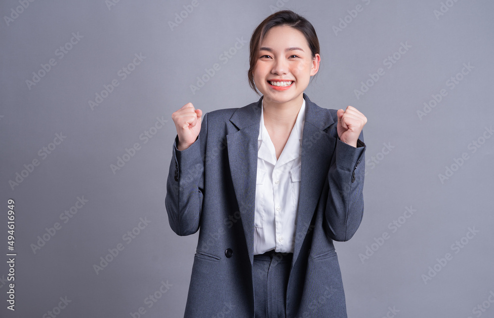 Portrait of a beautiful Asian businesswoman on a gray background Portrait of a beautiful Asian businesswoman on a gray background