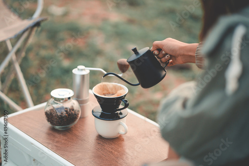 Happy woman relaxing in the holiday morning, traveling and slow life, resting style, camping. selective and soft focus. photo