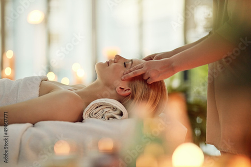 Restore balance to your whole body and mind. Cropped shot of a young woman enjoying a head massage at a spa. photo