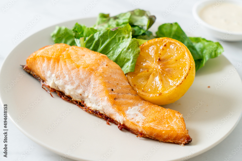 fried salmon steak with lemon and vegetable