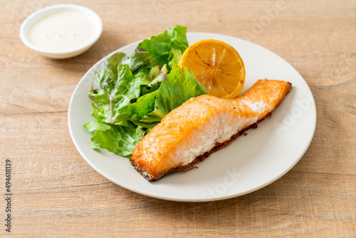 fried salmon steak with lemon and vegetable