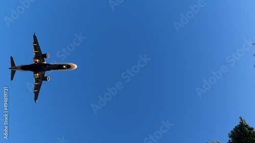 Plane landing on airport. Commercial Jet Plane Landing. Overhead flying aircraft landing. Airplane landing in LAX airport at sunset, Los Angeles, California USA.