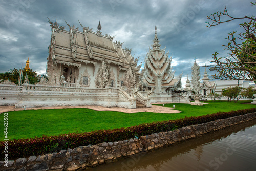 background Wat Rong Khun The White Temple and pond with fish, in Chiang Rai, Thailand © bangprik