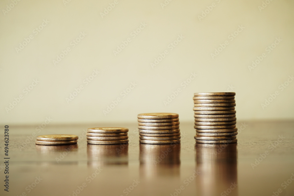 Money growth concept, where small coins in a pile gets bigger and higher for each pile Money growth concept, where small coins in a pile gets bigger and higher for each pile