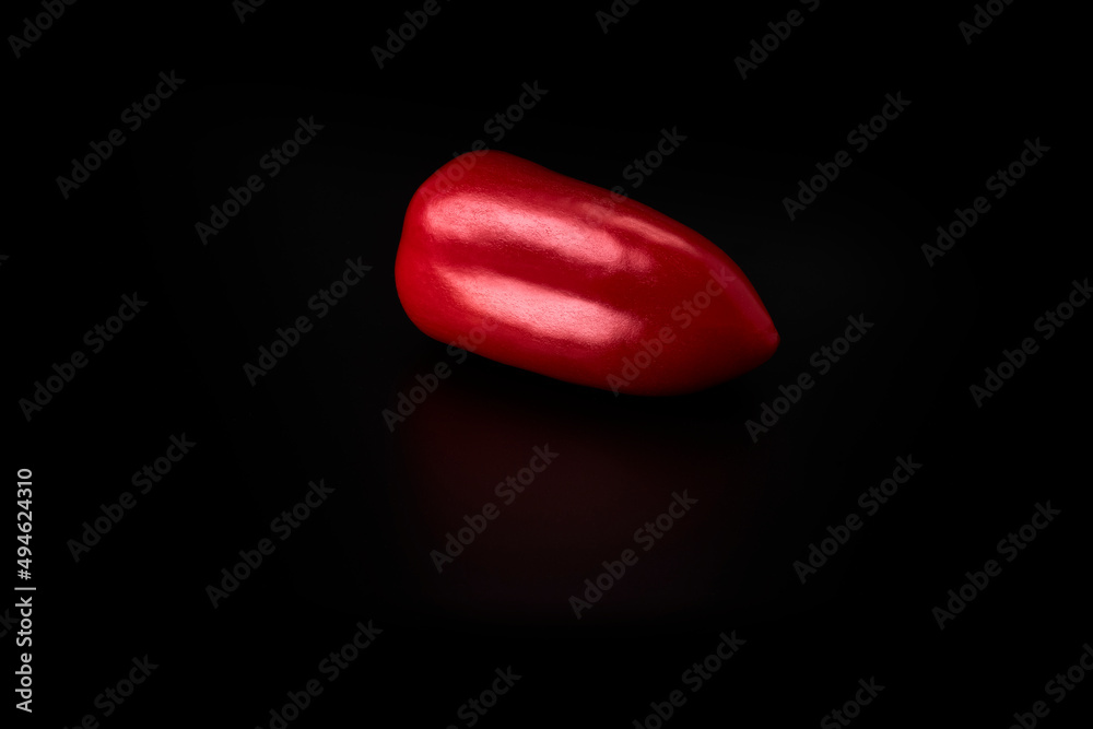 Red bell pepper on a black background. Vegan and vegetarian food Red bell pepper on a black background. Vegan and vegetarian food