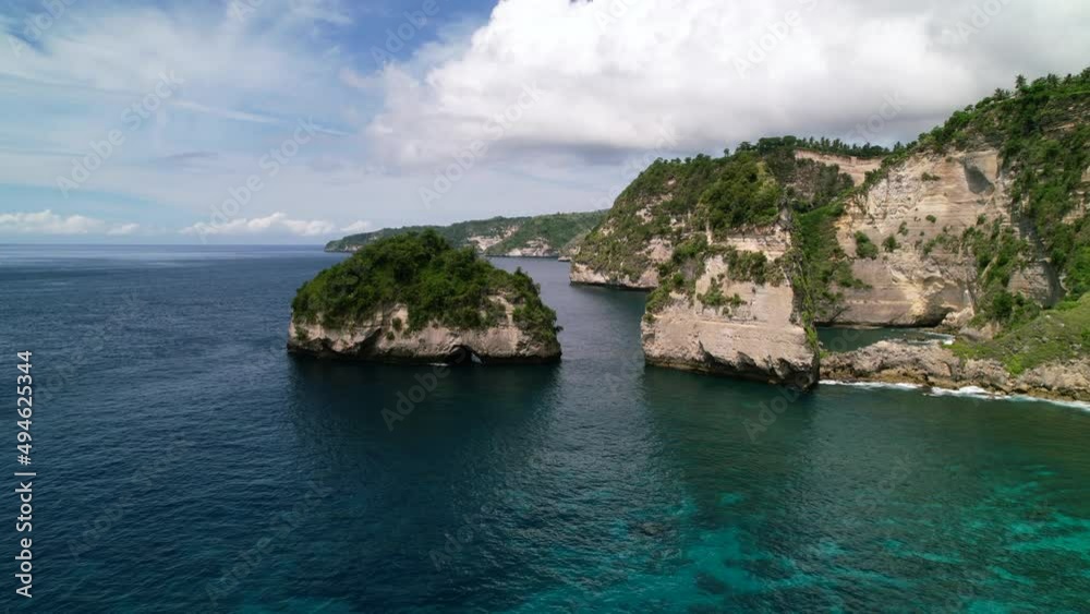 Aerial drone video of a tropical beach on Nusa Penida Island in Bali Indonesia. The beach is called Diamond Beach in Nusa Penida. Aerial drone video of a tropical beach on Nusa Penida Island in Bali Indonesia. The beach is called Diamond Beach in Nusa Penida.