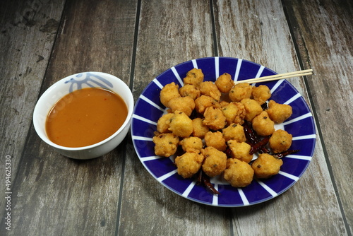 Traditional deep fried Bean cake (Bayia) serving on the plate. Famous Indian snack concept.