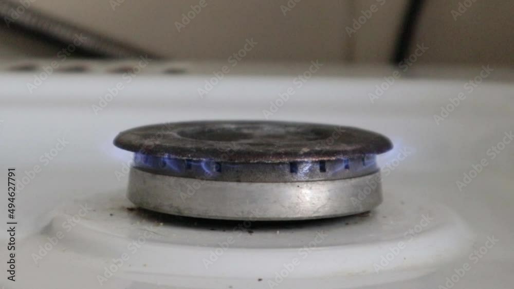 Gas burner on a kitchen stove for cooking with a burning propane fire. Natural gas ignites with a blue flame. Natural gas concept. The work of a fiery gas burner, fire on the stove. Gas burner on a kitchen stove for cooking with a burning propane fire. Natural gas ignites with a blue flame. Natural gas concept. The work of a fiery gas burner, fire on the stove.