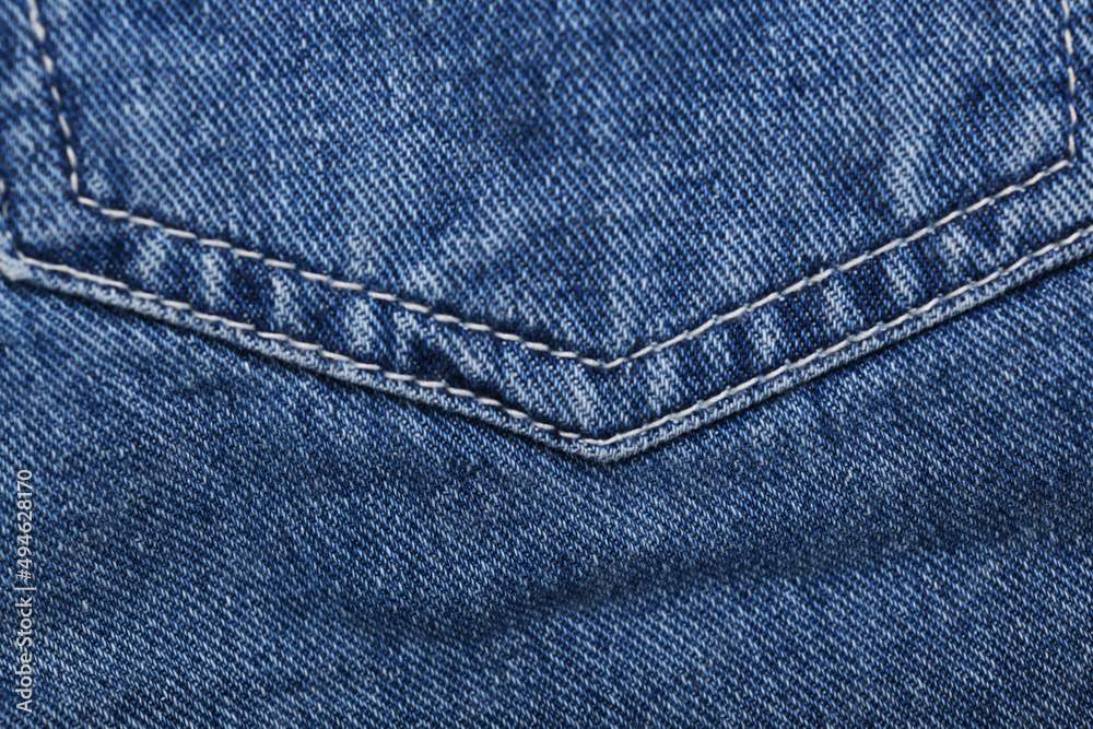 Old blue jeans background and texture close up.Denim seam. Old blue jeans background and texture close up.Denim seam.