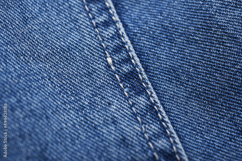 Old blue jeans background and texture close up.Denim seam. Old blue jeans background and texture close up.Denim seam.
