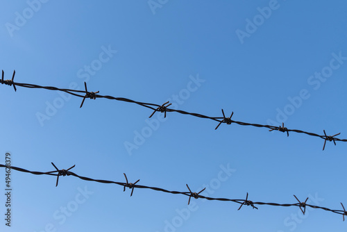 barbed wire and blue sky in the background