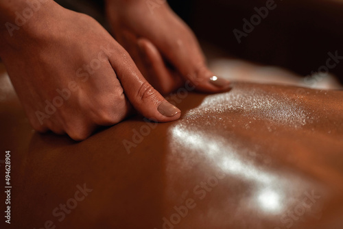 Close up of masseur doing back massage of woman