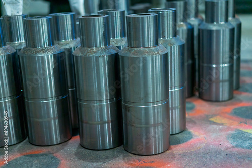 Metal products turned on a lathe are stored on the floor in the workshop. view from above. Metalworking of products on CNC machines. factory. sub detail