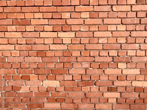 A wall made of red old bricks 