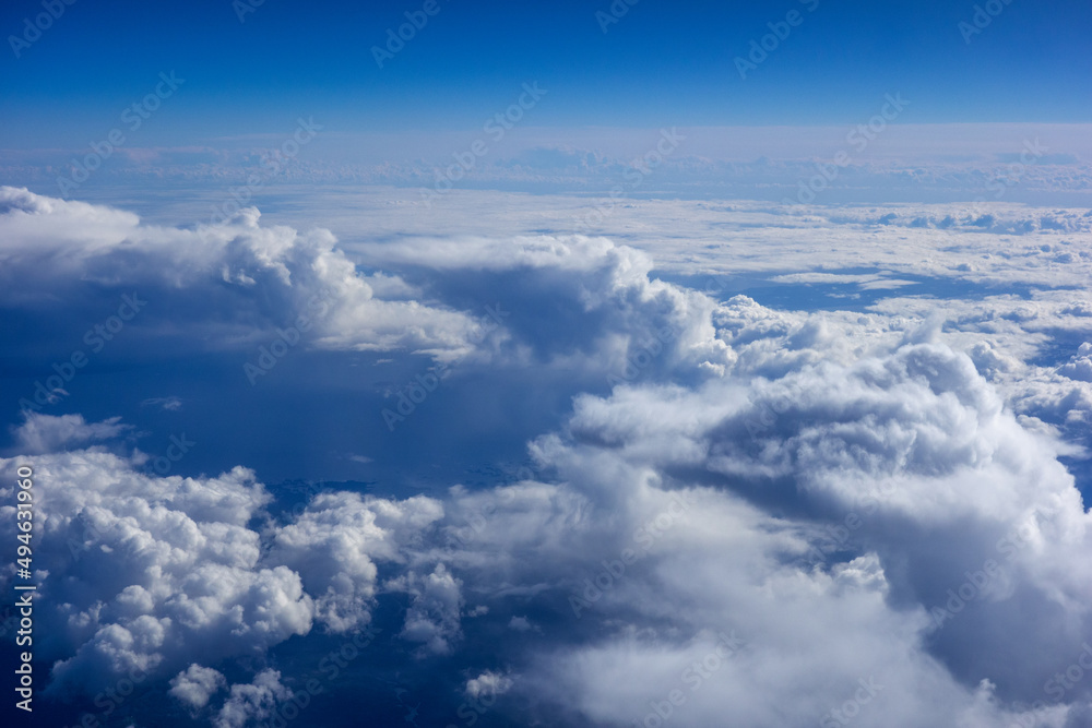 White fluffy clouds in a bright blue sky White fluffy clouds in a bright blue sky