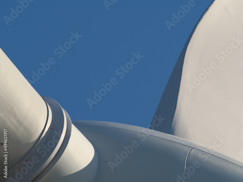 Close up of Windturbine producing alternative energy with a blue sky. Selective focus.