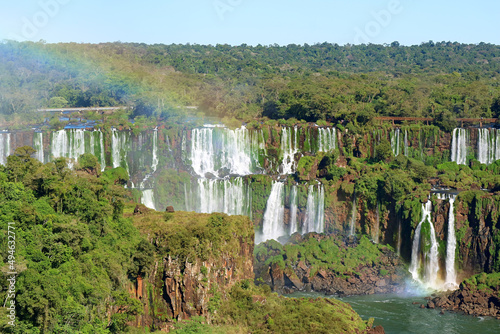 Impressive view of Iguazu falls with a rainbow at Brazilian side  Foz do Iguacu town  Brazil  South America
