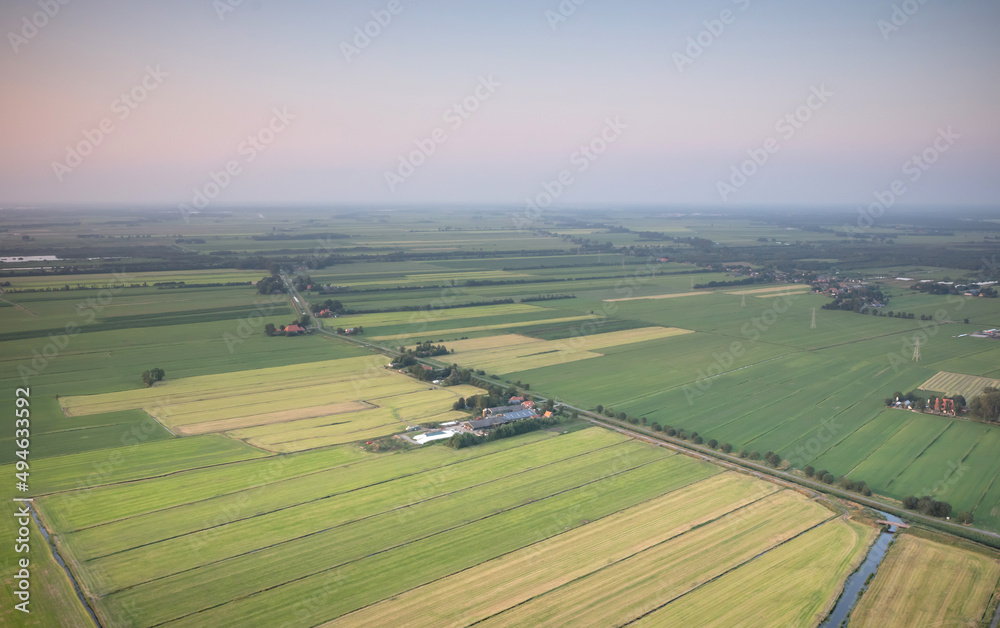 Agricultural landscape of Friesland, one of the northern provinces of the Netherlands - Friesland from above - Local farm with solar panels on roof