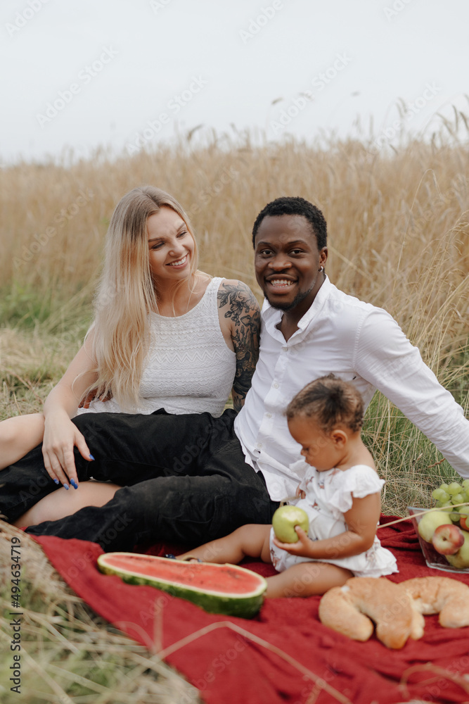 Carefree and joyful mixed race family in wheat fields Carefree and joyful mixed race family in wheat fields