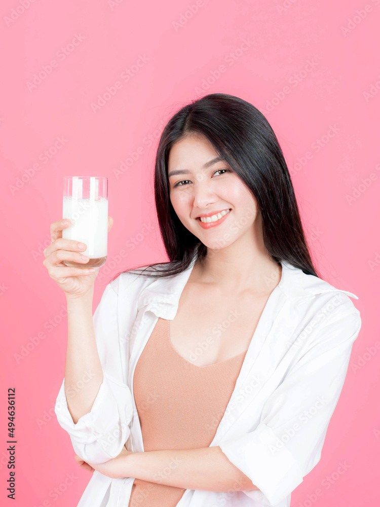 beauty woman Asian cute girl feel happy drinking milk for good health in the morning on pink background - lifestyle beauty woman c beauty woman Asian cute girl feel happy drinking milk for good health in the morning on pink background - lifestyle beauty woman c