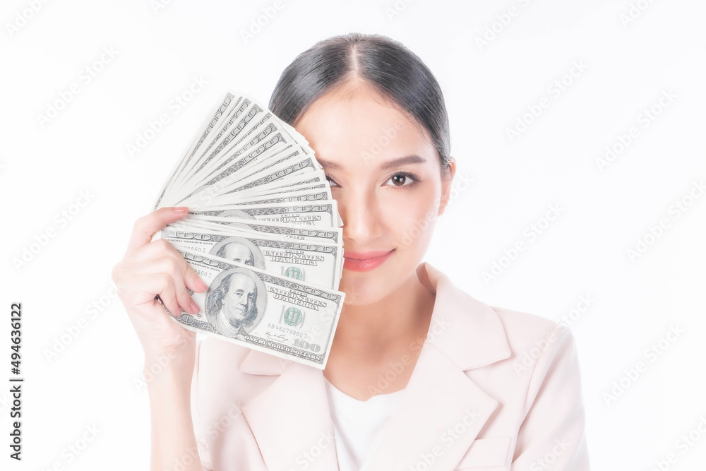 Successful beautiful Asian business young woman holding money US dollar bills in hand isolated on white background with copy space , business concept Successful beautiful Asian business young woman holding money US dollar bills in hand isolated on white background with copy space , business concept