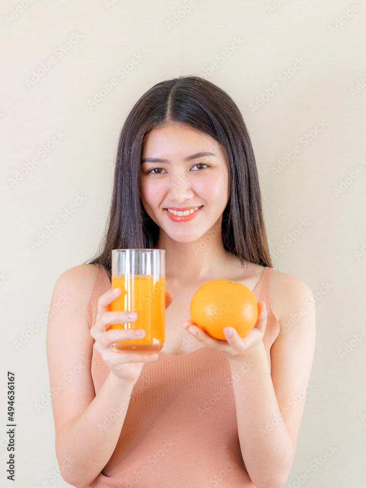 Beautiful beauty woman Asian cute girl feel happy drinking orange juice for good health in the morning , enjoying time in her home white bedroom background - lifestyle beauty woman concept Beautiful beauty woman Asian cute girl feel happy drinking orange juice for good health in the morning , enjoying time in her home white bedroom background - lifestyle beauty woman concept