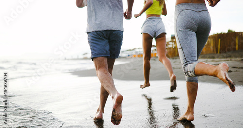 Fitness, sport, friendship and healthy lifestyle concept . Group of happy people jogging