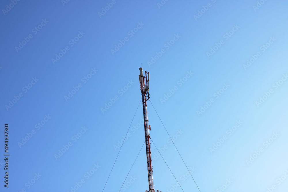 High pole with communication wires on the blue sky High pole with communication wires on the blue sky