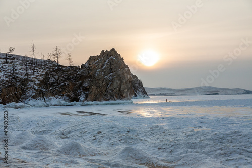 Baikal frozen lake at sunset  Olkhon island. Clear ice and snow