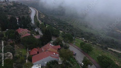 Housing in green highlands wide pastures in mountains and blue skies land Israel Katzir high mountain drone aerial view landscape. photo