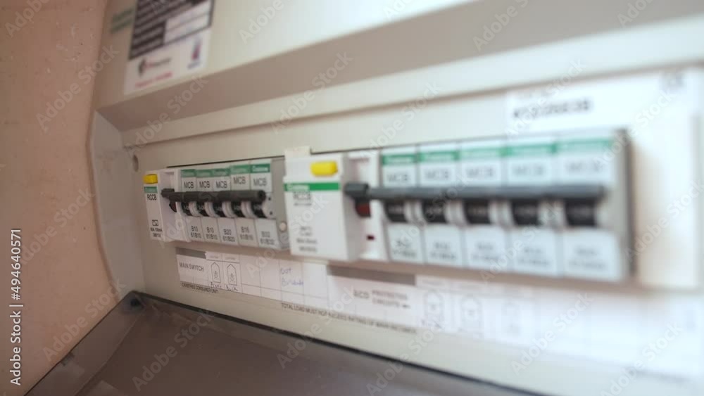 A man resets a tripped fuse in a power circuit breaker electricity