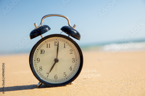 alarm clock on the beach- travel, business or last minute concept