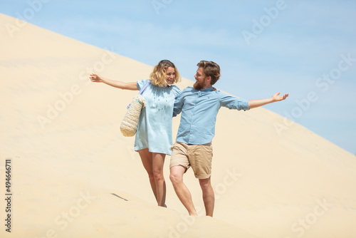 a romantic young man and woman couple on sand dunes