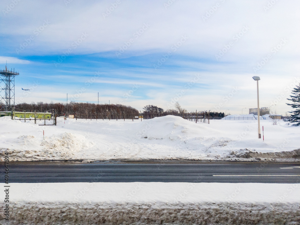 Snowy roadway by an airport (Chitose, Hokkaido, Japan)