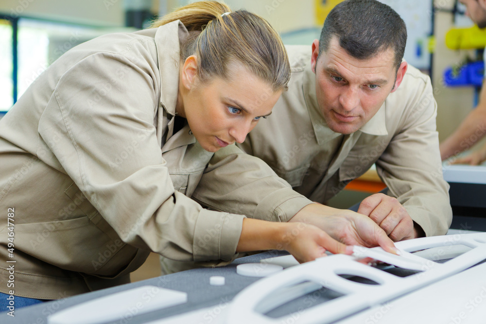 Obraz premium woman fixing something in factory