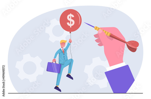 Financial crisis. A hand throws a dart at a balloon with a businessman