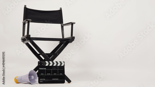 Black director chair and black Clapper board or movie Clapperboard put on floor with megaphone on white background.