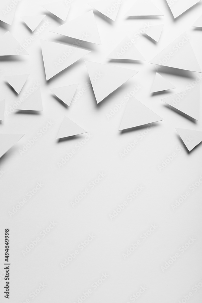 White paper triangles as abstract pattern in bright light with soft light shadows, border, copy space, top view. Airy tender softness modern background in future minimalistic style. White paper triangles as abstract pattern in bright light with soft light shadows, border, copy space, top view. Airy tender softness modern background in future minimalistic style.
