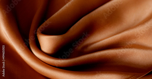 close up of clothes in natural tones - satin silk soft texture - lights and shadows
