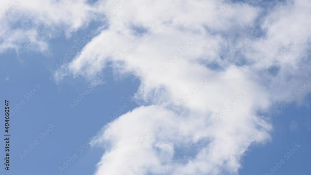 Fluffy white clouds moving across blue sky Fluffy white clouds moving across blue sky