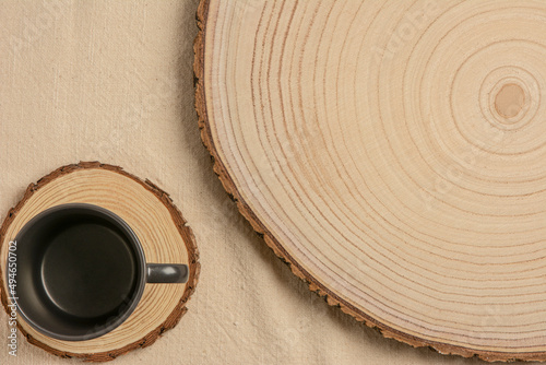 Rustic, wood texture background. Dramatic light, natural pattern. Cozy soft winter vintage background. Beige Vintage towel with a grey ceramic empty mug, flat lay.	
